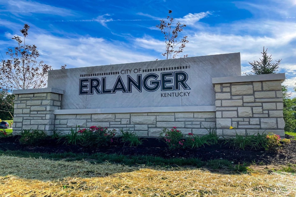 Erlanger Ky | LandCo Group Entrance sign for the City of Erlanger, Kentucky, built with stone pillars and landscaped beds under a blue sky