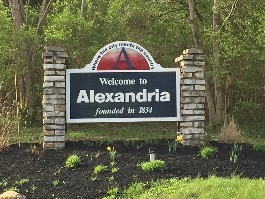 Alexandria KY | LandCo Group Welcome sign for Alexandria with a stone-pillared display and the text 'Welcome to Alexandria founded in 1834' against a wooded background.